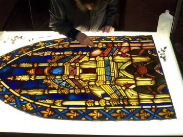 cleaning the painted surface of a stained glass panel 